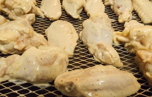 Chicken wings on oven rack ready to bake-Oven Fried Chicken Wings in Chipotle Sauce