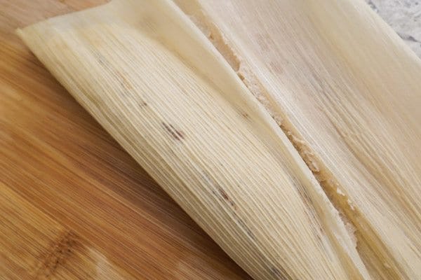 Folding corn husk over masa dough-Beef Mexican Tamales