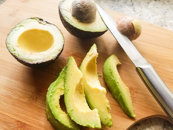 Cutting avocados and making slices for avocado wedges for the Fried Avocado Dippers.