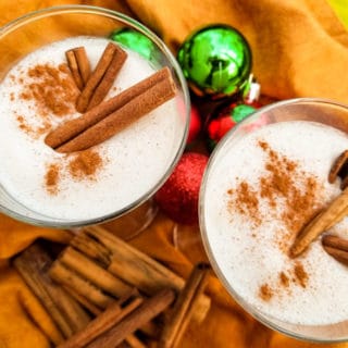 A delicious coquito recipe-coconut eggnog made with evaporated milk, coconut milk, cream of coconut, sweetened condensed, vanilla and cinnamon. Served with or without rum. Creamy and absolutely delicious! | mexicanappetizersandmore.com