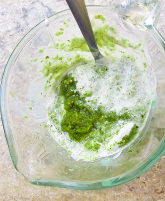 Mixing the Creamy Sour Cream Salsa Verde Sauce in a measuring cup.