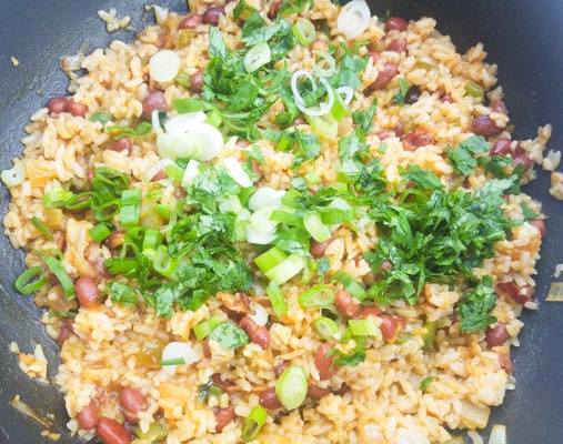 After mixing all the ingredients together also combine scallions and cilantro to the Arroz Mamposteao