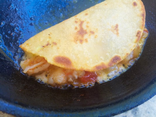 Tacos cooking and crisping up in skillet-Tacos Gobernador