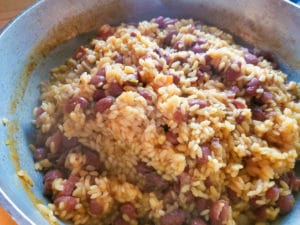 Stir rice with a large spoon after liquid has dried out. - Puerto Rican Rice and Beans (Arroz y Habichuelas)