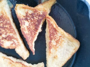 Cooked dulce de leche french toast in a skillet.