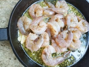 Jumbo shrimps added to the cast iron of garlic, butter, lemon and wine.