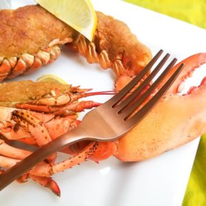 Crispy Garlic Topping Baked Lobster (with Shrimp) on a white platter with lemon wedges.