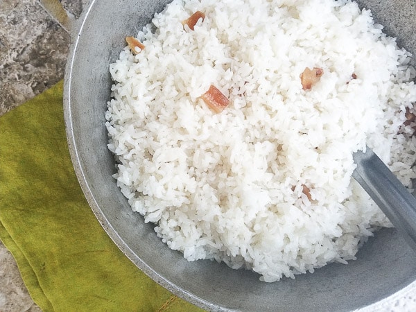 Arroz Blanco (Puerto Rican White Rice) cooked in a caldero with pieces of tocino (pork fat).