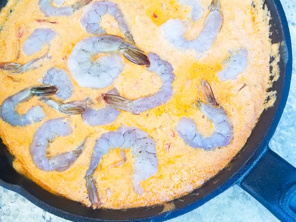 Raw shrimps added to the skillet with the creamy chipotle sauce.