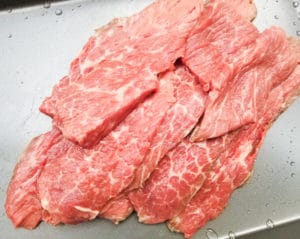 Beef thinly sliced for beef skewers.
