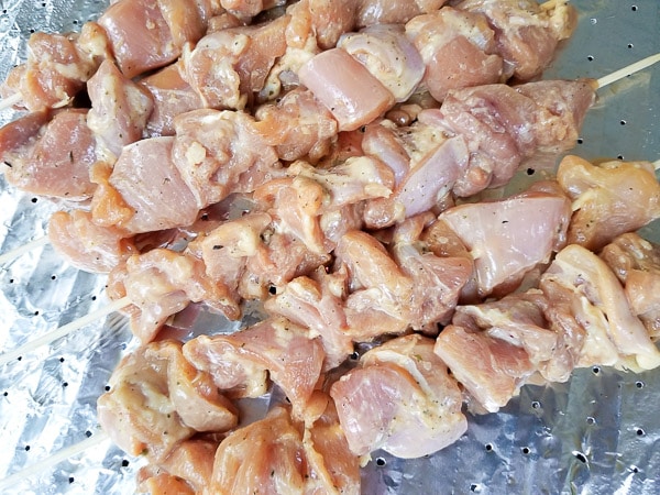 Chicken skewers on grill.