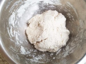 Ball of dough in a large bowl, ready to be baked.
