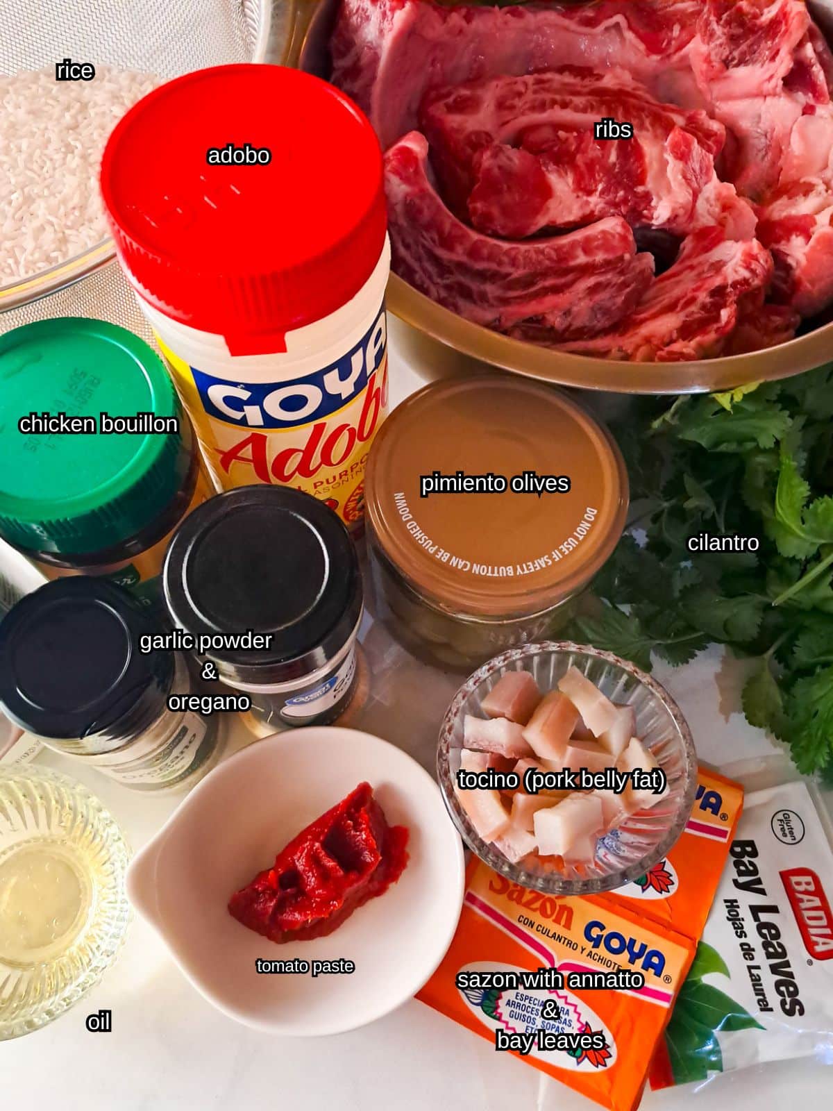 An image of all the ingredients needed to make arroz con costillas.