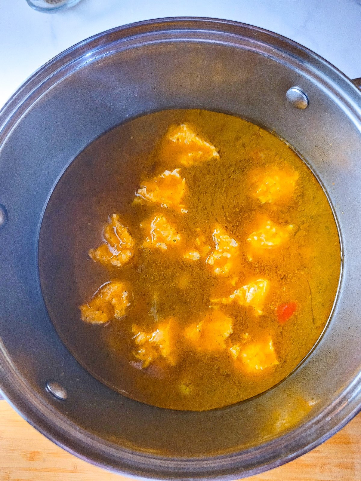 The bolitas de platanos (plantain dumplings) added to the stew.