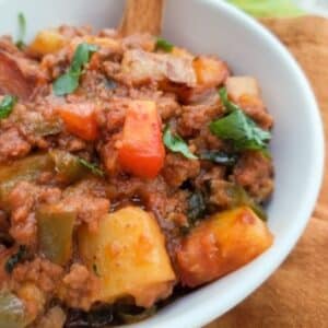 Authentic Mexican picadillo recipe with potatoes served in a white bowl.