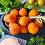 Bolitas de Queso served with a side of mayoketchup.