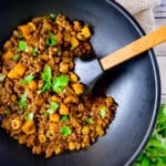 Carne Molida (Puerto Rican Picadillo) cooked in a black skillet.