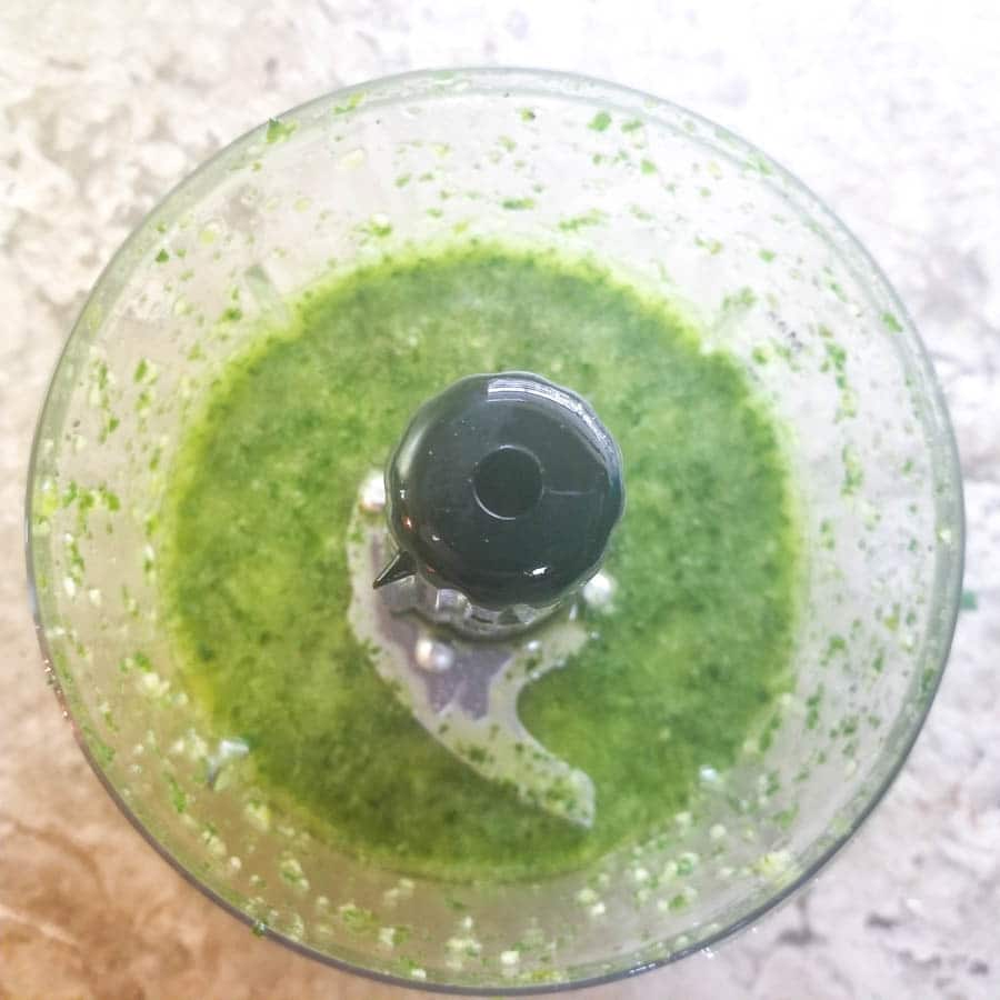 Blended cilantro garlic salsa in a small food chopper.
