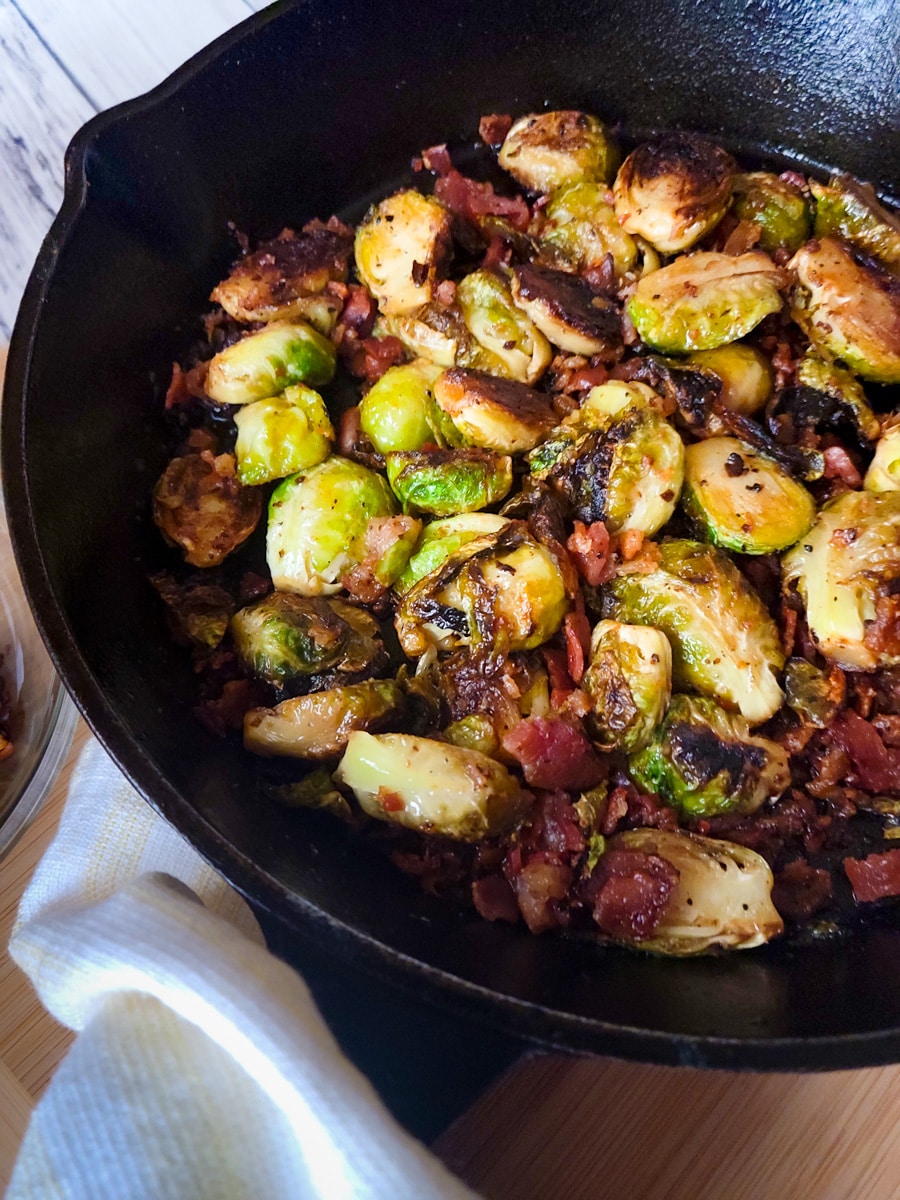 Coles de Bruselas (Brussels Sprouts with Bacon) served in cast iron pan.