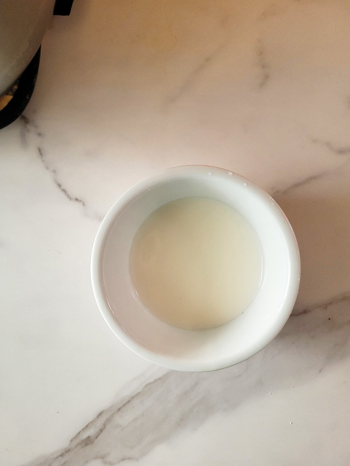 Slurry mix in a small white bowl.