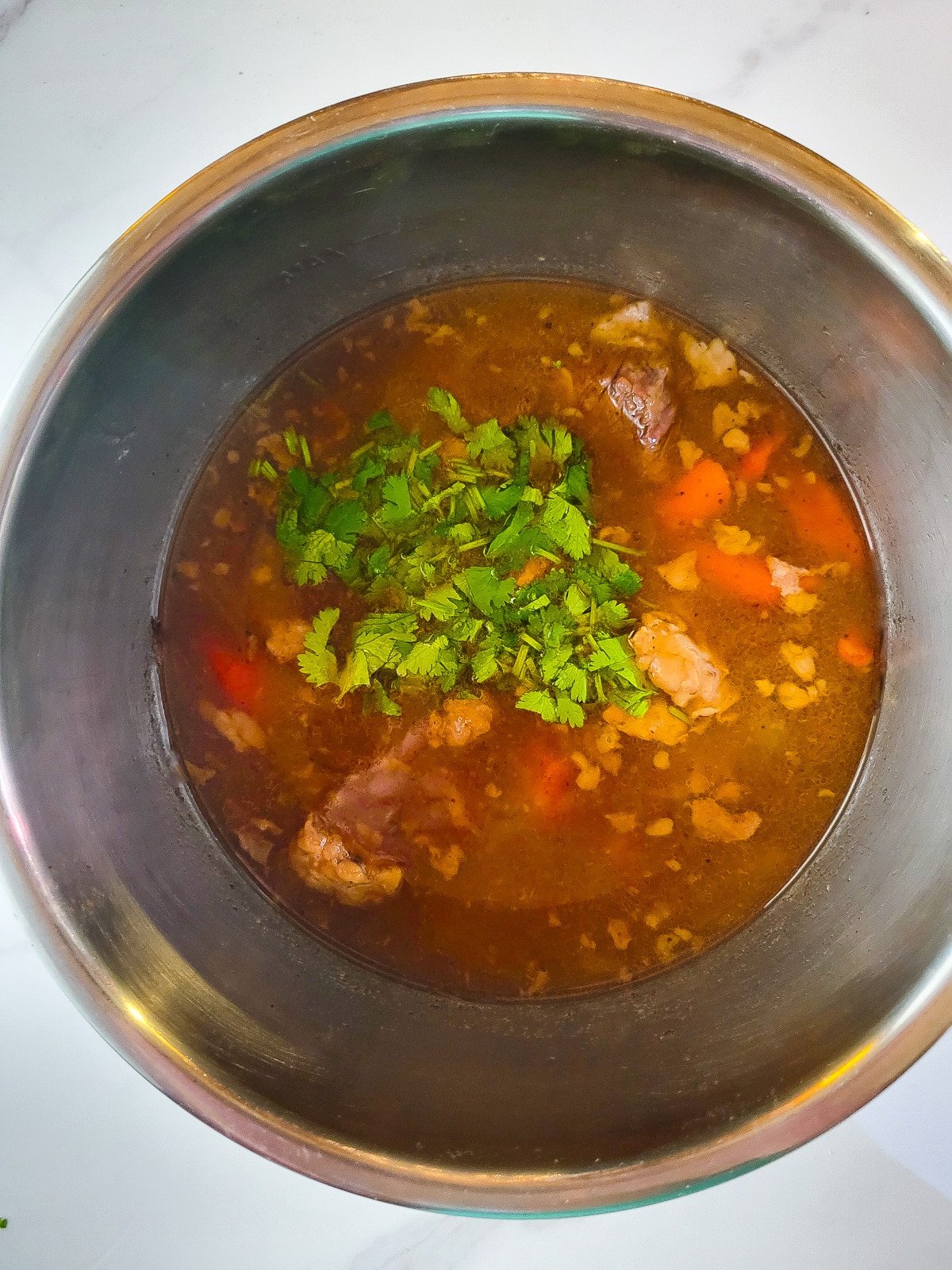 Chopped cilantro added to the diezmillo guisado (stew).