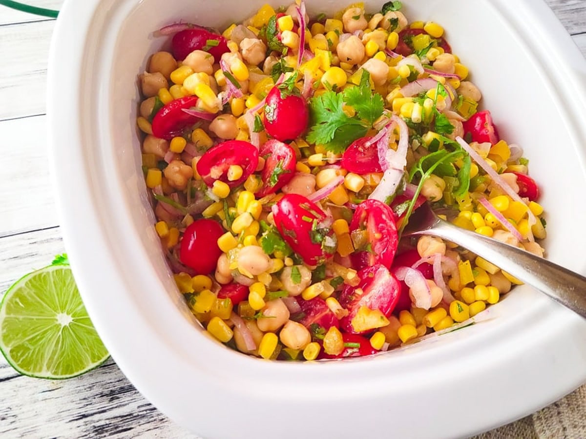 Ensalada de garbanzos served in a white casserole dish.