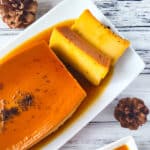 Flan de Café (Coffee Flan) on a white platter and a smaller flan on another white plate topped with coffee granules.