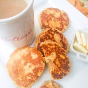Gorditas de Azucar (Sugar Gorditas) served on a white plate with a side of coffee.