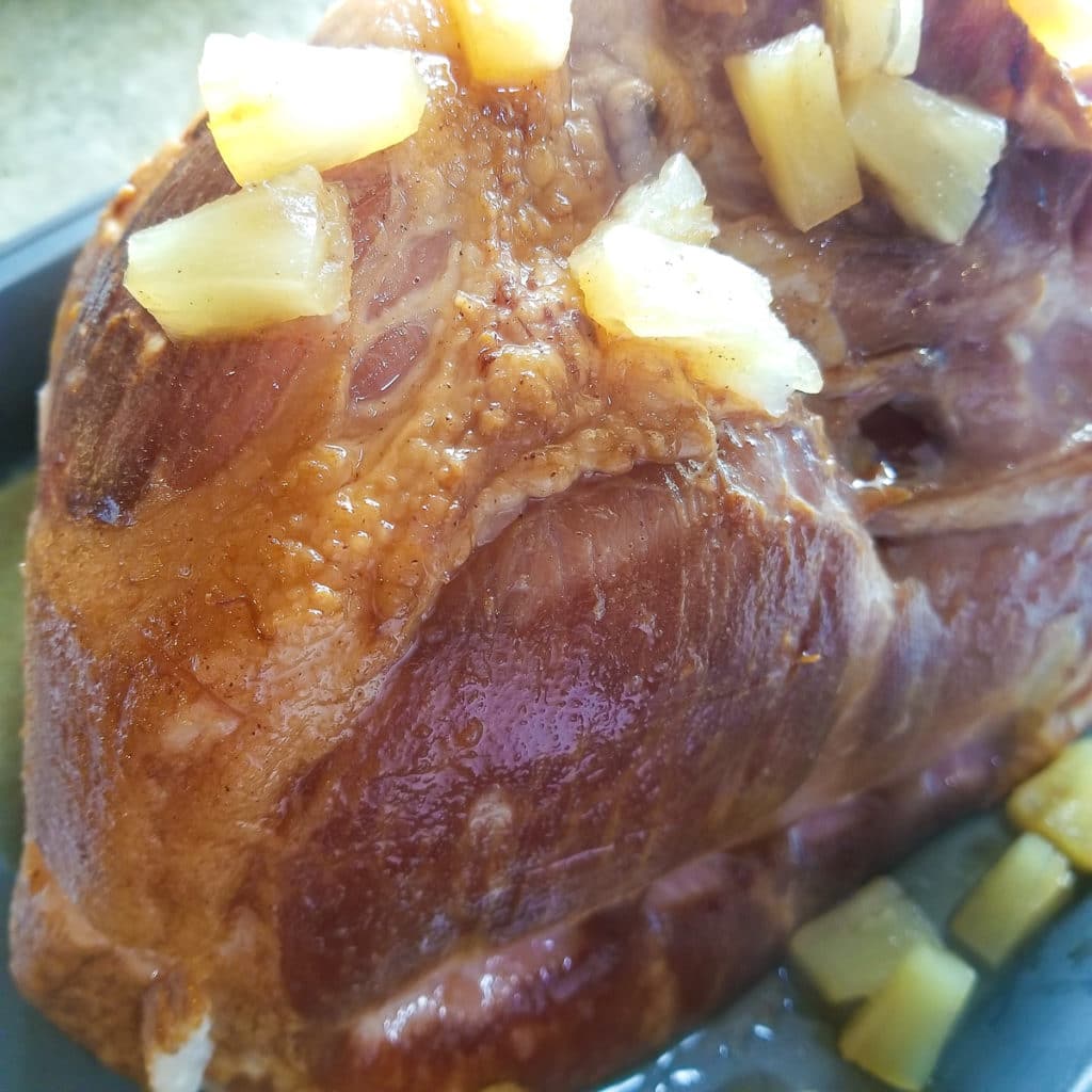 Ham topped with the pineapple glaze ready to bake.