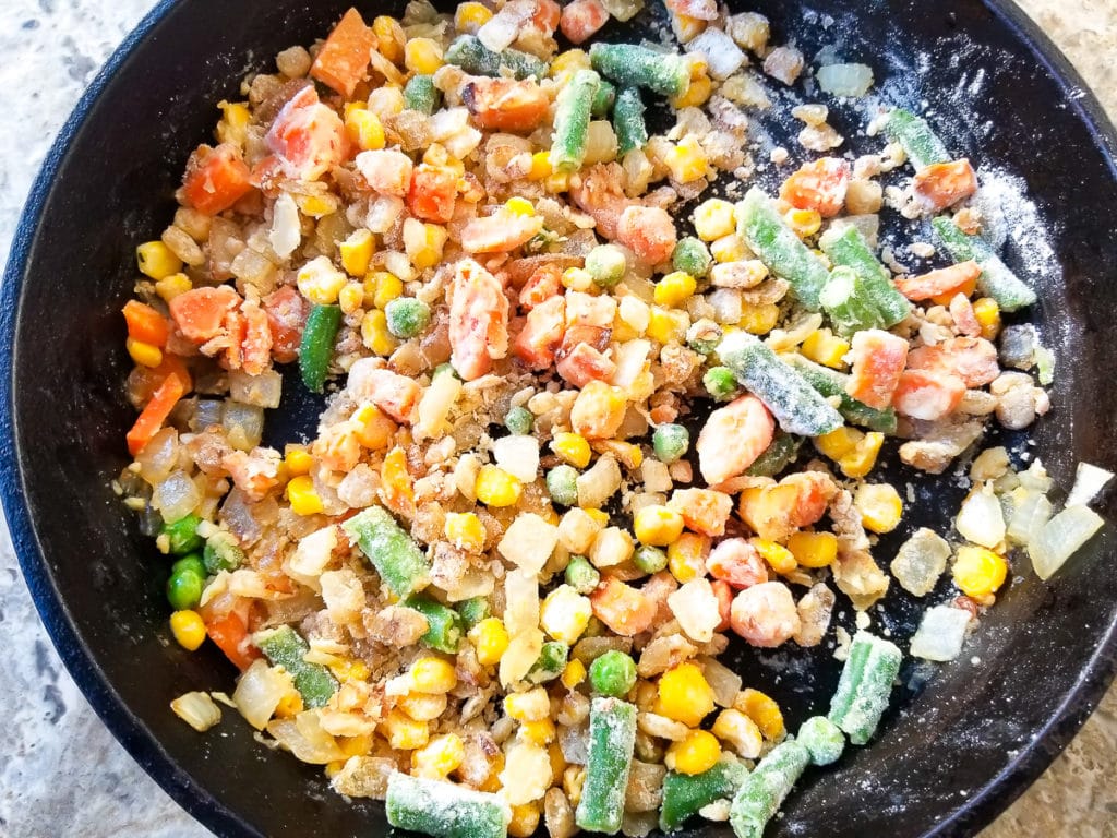 Flour added to skillet with veggies.