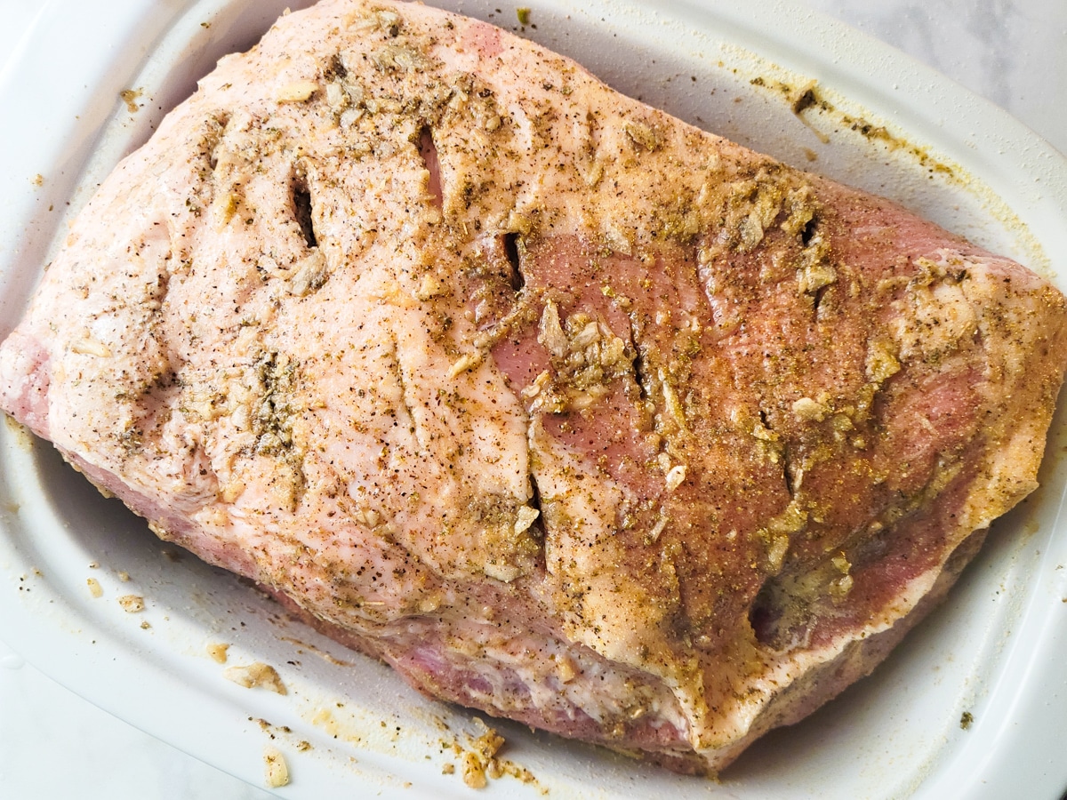 The boston butt has been seasoned with the adobo and garlic, oregano mixture.