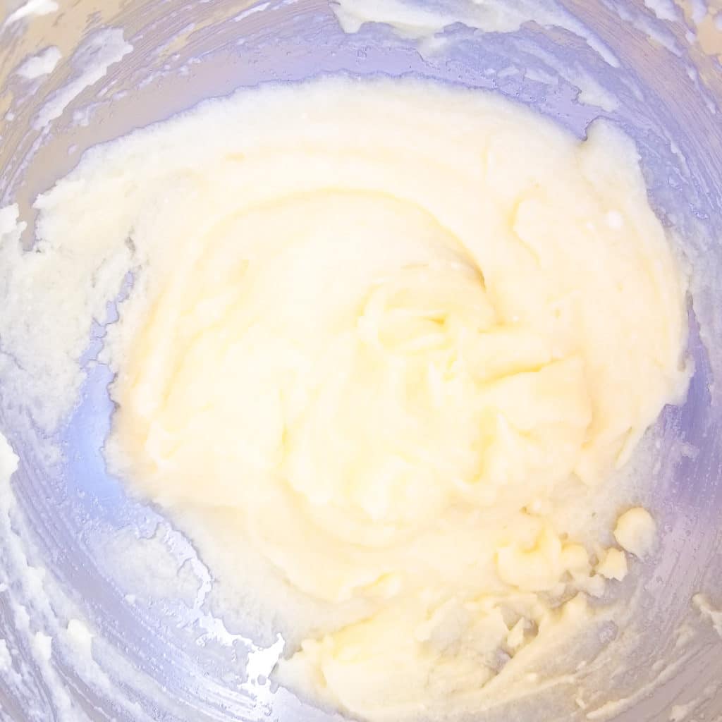 Butter and sugar mixed together in a mixing bowl for pan de maiz.