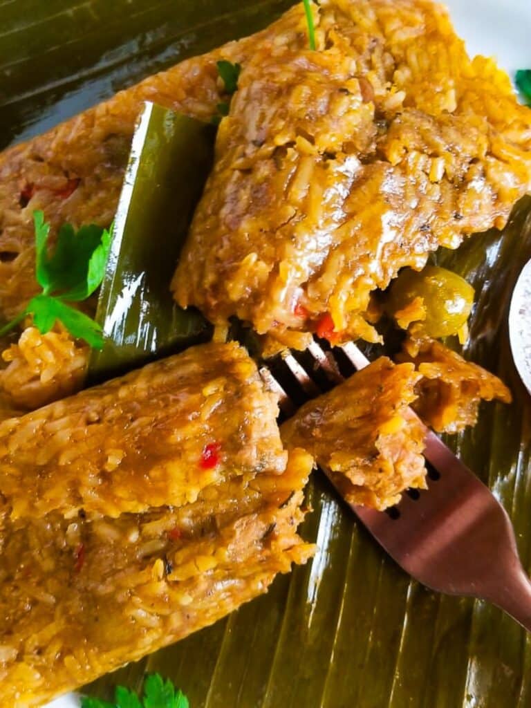 Pasteles de arroz (rice pasteles) served on a white plate with a fork.