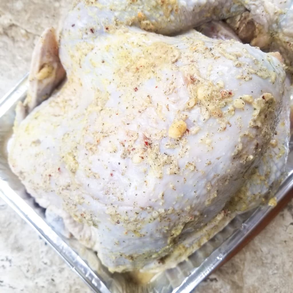 Turkey marinating in a tray.