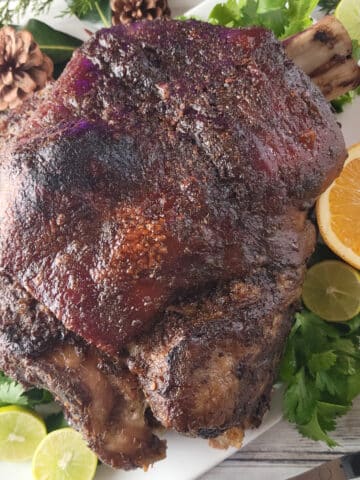 Puerto Rican Pernil served on a white platter.