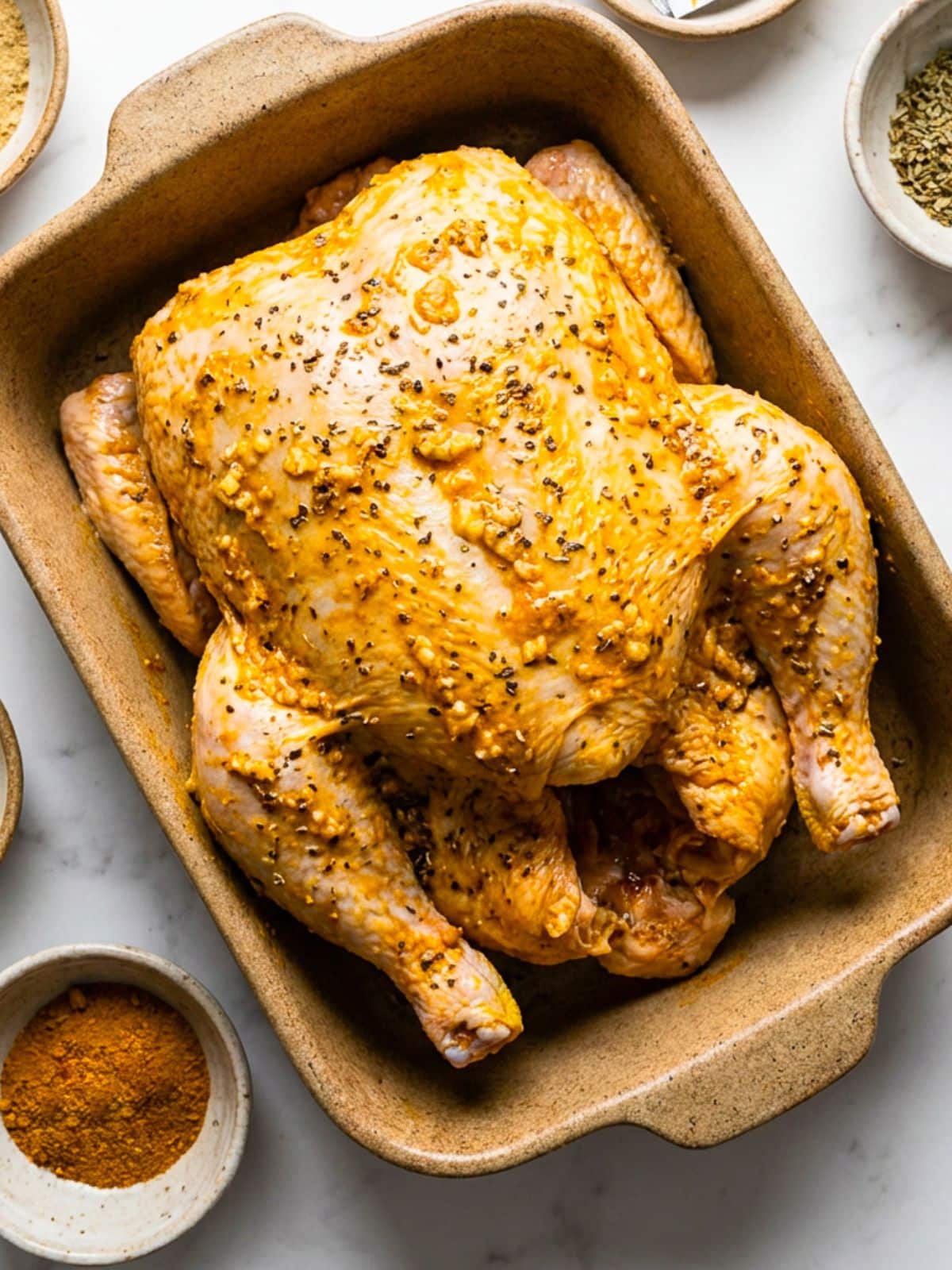 A whole chicken marinated in the Puerto Rican pollo asado marinade.