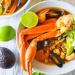 Pozole de Mariscos served in white soup bowls.