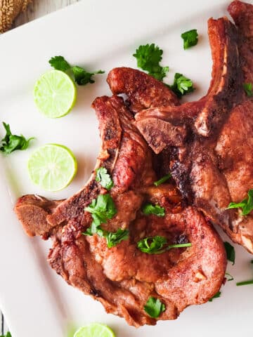 Puerto Rican Fried Pork Chops served on a white platter.