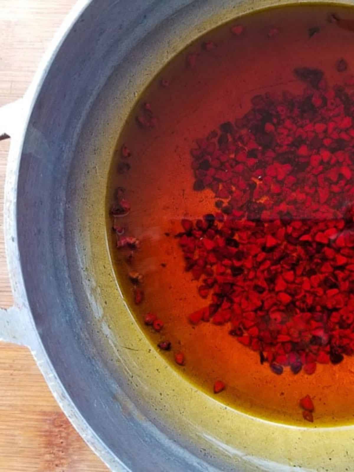 Achiote (annatto oil) made in a caldero.