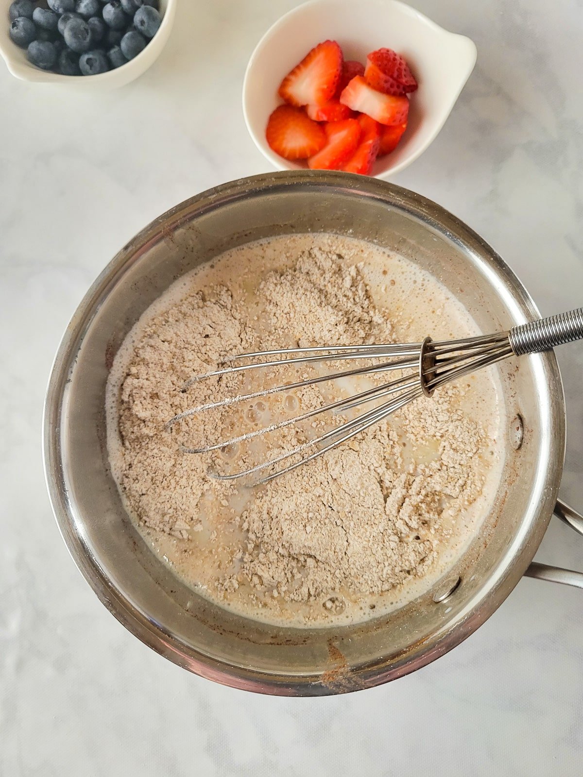 Old fashioned oats added to the saucepan of milk.