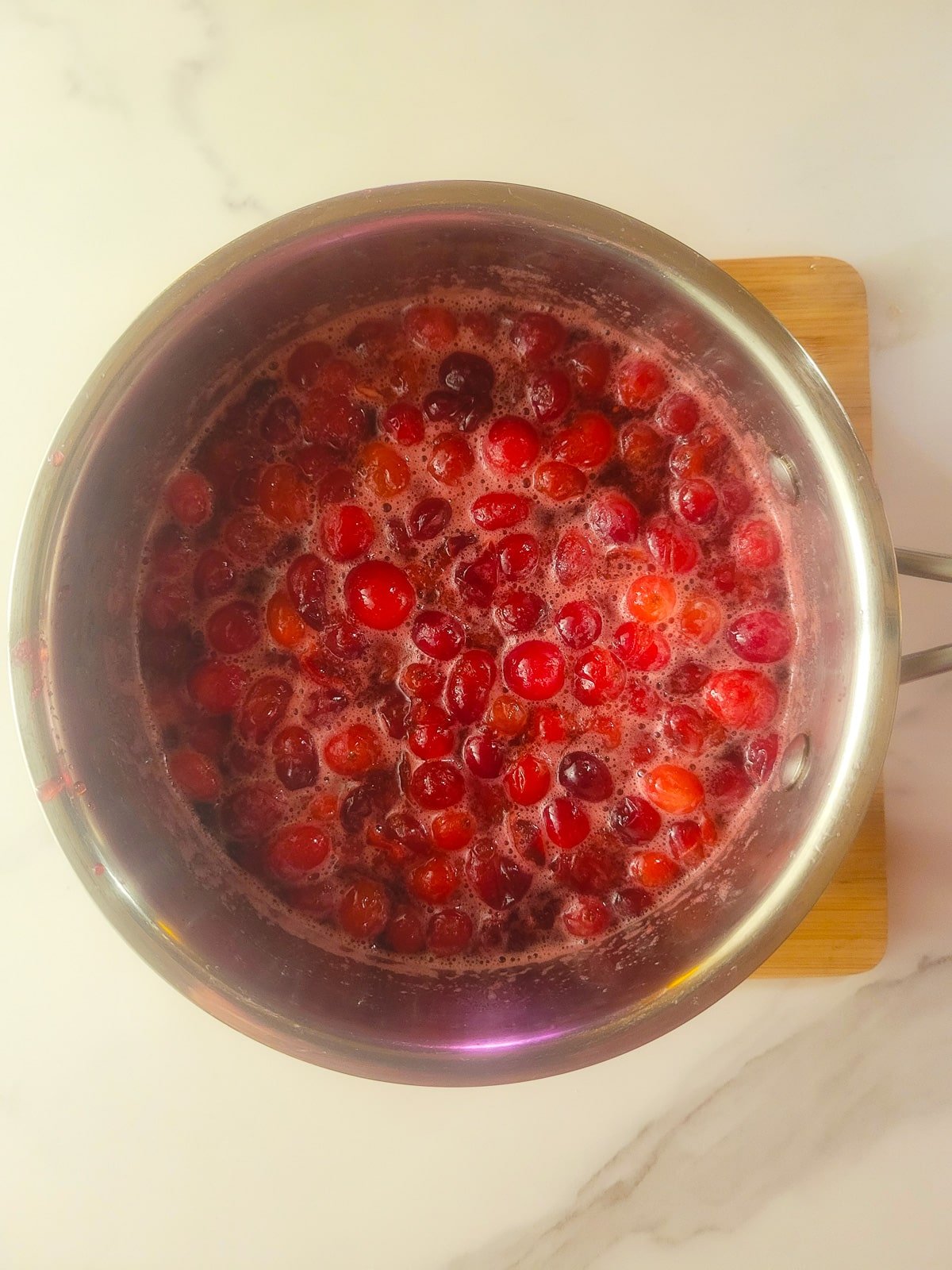 Cooking the cranberry sauce in a saucepan.