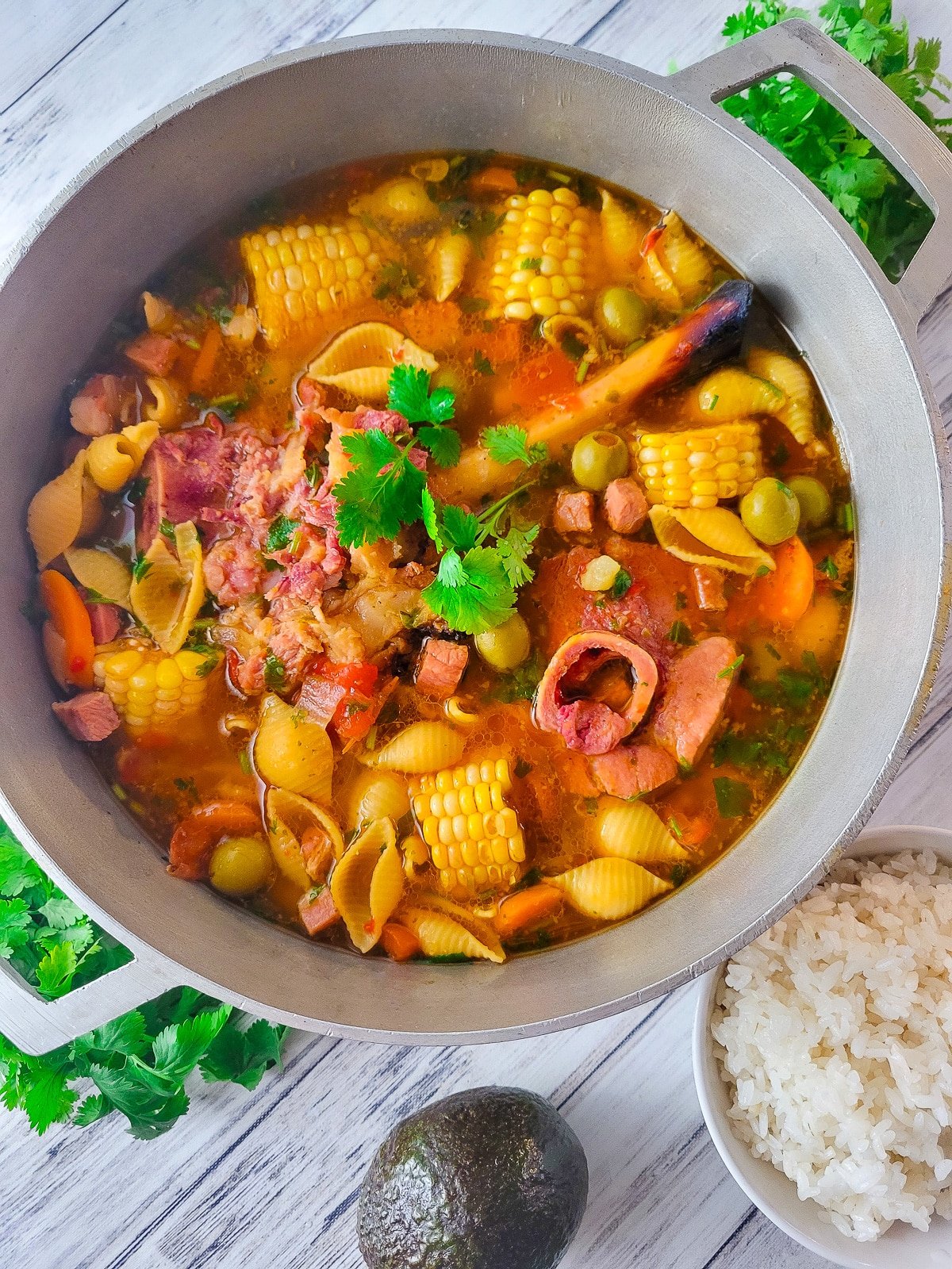 Sopa de Jamón cooked in a Puerto Rican caldero with a side of white rice and avocado.