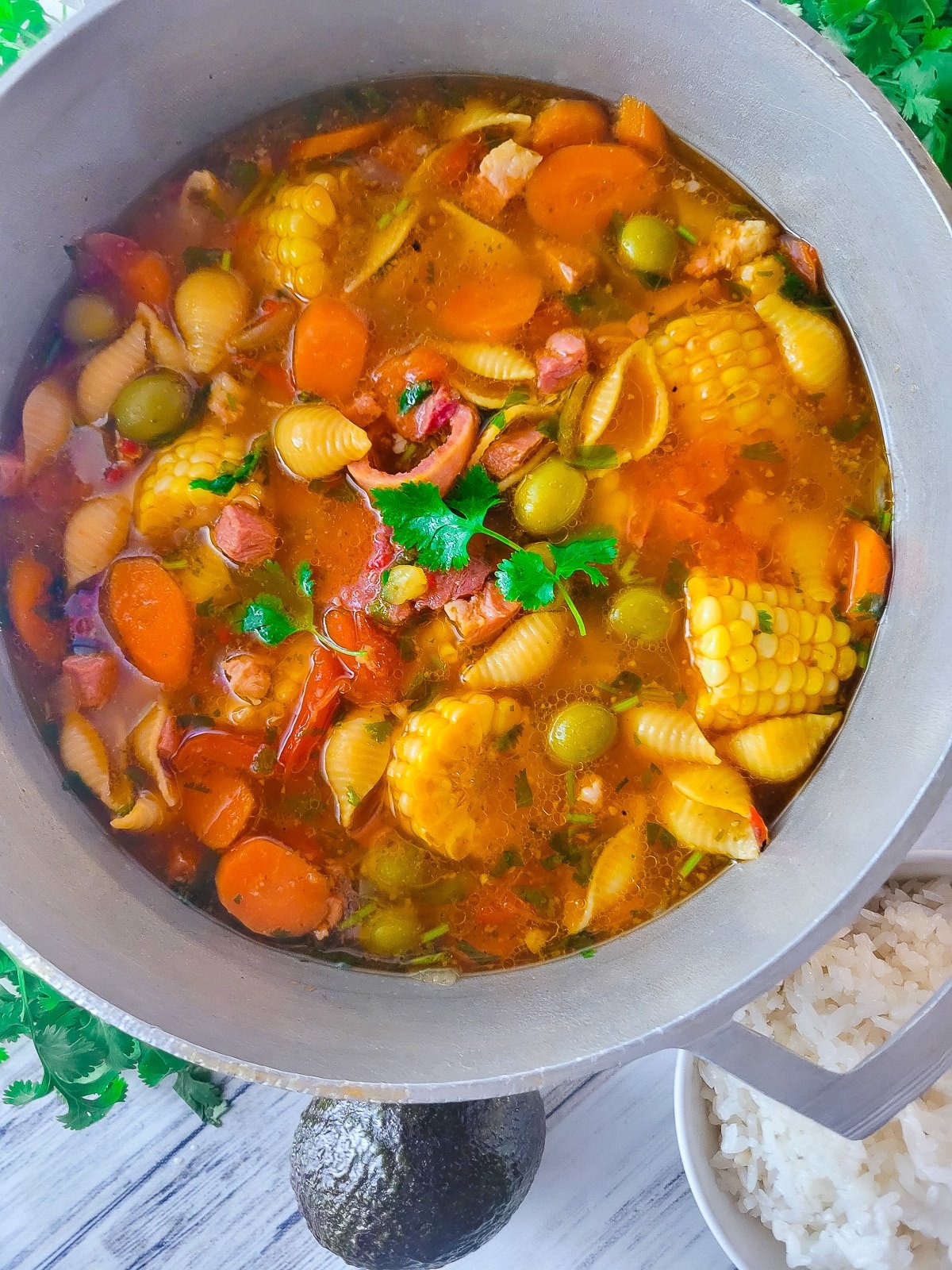 Sopa de Jamón cooked in a Puerto Rican caldero with a side of white rice and avocado.