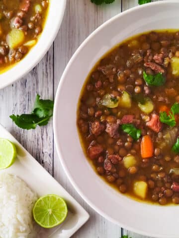 Sopa de Lentejas (Lentil Soup) served in white bowls with a side of Puerto Rican white rice,