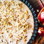 Tembleque de Coco served in a rimmed mold, topped with coconut flakes.